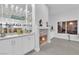 Elegant bar area with a fireplace, custom cabinetry, and stylish decor at 9609 Eagle Valley Dr, Las Vegas, NV 89134
