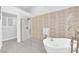 Bright bathroom showcases textured tile, glass shower, and modern soaking tub at 9609 Eagle Valley Dr, Las Vegas, NV 89134