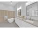 Spa-like bathroom featuring modern fixtures, a soaking tub, and dual sinks at 9609 Eagle Valley Dr, Las Vegas, NV 89134
