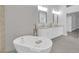 Beautiful bathroom featuring double sink vanity, a soaking tub, and modern fixtures at 9609 Eagle Valley Dr, Las Vegas, NV 89134