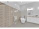 Bright bathroom features a modern soaking tub, textured tile, and updated fixtures at 9609 Eagle Valley Dr, Las Vegas, NV 89134