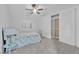 Cozy bedroom with neutral tones, a ceiling fan, plush carpet, and a shuttered window at 9609 Eagle Valley Dr, Las Vegas, NV 89134