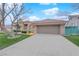 Single-story house with a red tile roof and an extended driveway leading to an attached two-car garage at 9609 Eagle Valley Dr, Las Vegas, NV 89134