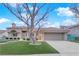 Inviting single-story home boasts a red tile roof, artificial turf, and an attached two-car garage with ample parking at 9609 Eagle Valley Dr, Las Vegas, NV 89134
