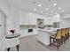 Modern kitchen boasts bright white cabinetry, stainless steel appliances, and a large center island at 9609 Eagle Valley Dr, Las Vegas, NV 89134