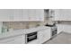 Modern kitchen featuring white cabinetry, granite countertops, and stainless steel appliances at 9609 Eagle Valley Dr, Las Vegas, NV 89134