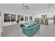 Bright, open living room featuring sleek tile floors, white walls, and kitchen with modern finishes at 9609 Eagle Valley Dr, Las Vegas, NV 89134