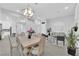 Spacious living space with fireplace, dining table, and view to a bright kitchen at 9609 Eagle Valley Dr, Las Vegas, NV 89134