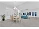 Expansive living area with dining table, fireplace, and a view of the rear lounge at 9609 Eagle Valley Dr, Las Vegas, NV 89134