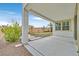 Covered patio with pebble landscaping and small pool in the background at 10273 Sierra Skye Ave, Las Vegas, NV 89166