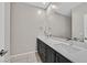 Clean bathroom with double sinks and a large mirror at 10273 Sierra Skye Ave, Las Vegas, NV 89166