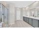 Bathroom with dual vanity, large mirror, and modern gray cabinets at 10273 Sierra Skye Ave, Las Vegas, NV 89166