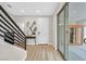 Light and bright entryway with wood-look floors, modern staircase, and access to a private sauna at 10273 Sierra Skye Ave, Las Vegas, NV 89166