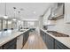 Modern kitchen with gray cabinetry, quartz countertops, and stainless steel appliances at 10273 Sierra Skye Ave, Las Vegas, NV 89166