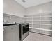 Laundry room with washer, dryer, and ample shelving at 10273 Sierra Skye Ave, Las Vegas, NV 89166