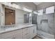 Modern bathroom with double vanity, marble countertops and a large shower at 10525 Findlay Ave, Las Vegas, NV 89134