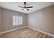 Spacious bedroom with wood-look floors and window shutters at 10525 Findlay Ave, Las Vegas, NV 89134