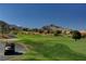 Golf course with mountain views and a golf cart on a path at 10525 Findlay Ave, Las Vegas, NV 89134