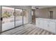 Kitchen with white cabinets and view of backyard through sliding doors at 10525 Findlay Ave, Las Vegas, NV 89134