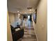 Hallway overlooking staircase with wood floors, white railings, and a cozy chair at 1136 Buckhorn Cove St, Henderson, NV 89011