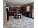 Spacious kitchen featuring a large island, dark cabinets, and granite countertops at 1136 Buckhorn Cove St, Henderson, NV 89011