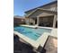 Relaxing backyard pool area features a covered patio with outdoor seating at 1136 Buckhorn Cove St, Henderson, NV 89011