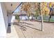 The backyard has gravel area, artifical turf, some mature trees, and a white privacy fence at 1403 5Th Pl, Las Vegas, NV 89104