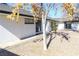 Backyard with gravel area, mature trees, and the exterior of the house with a sliding glass door at 1403 5Th Pl, Las Vegas, NV 89104
