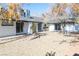 Spacious backyard with multiple sliding doors, mature trees, and a gravel area; ideal for outdoor living at 1403 5Th Pl, Las Vegas, NV 89104