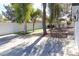 Private backyard featuring a white fence, mature trees, artificial turf, and concrete; ideal for relaxation at 1403 5Th Pl, Las Vegas, NV 89104