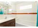 Well-lit bathroom featuring tiled walls, a vanity, and a shower-tub combination at 1403 5Th Pl, Las Vegas, NV 89104