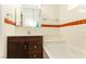 Well-lit bathroom with a dark vanity and tub detail at 1403 5Th Pl, Las Vegas, NV 89104