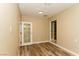 Bedroom features wood floors, neutral paint, access to a closet, and sliding glass door to the outside at 1403 5Th Pl, Las Vegas, NV 89104