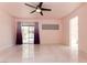 Spacious bedroom with tile floors, ceiling fan, and sliding glass doors to the backyard at 1403 5Th Pl, Las Vegas, NV 89104