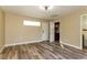 Bedroom with hardwood floors and a partially opened door to the bathroom at 1403 5Th Pl, Las Vegas, NV 89104