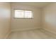 Empty bedroom with tiled floors, baseboard trim, and a window with blinds at 1403 5Th Pl, Las Vegas, NV 89104