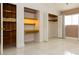 View of a bedroom closet with built-in wooden shelves and a built-in desk at 1403 5Th Pl, Las Vegas, NV 89104