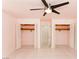 Bedroom featuring tiled floors, a ceiling fan, and closets with louvered doors at 1403 5Th Pl, Las Vegas, NV 89104