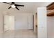 Spacious bedroom with a ceiling fan, tiled floor, and two closet doors with built-in shelves at 1403 5Th Pl, Las Vegas, NV 89104