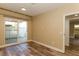 Bedroom features wood floors, neutral paint, a sliding glass door, and access to an en-suite bathroom at 1403 5Th Pl, Las Vegas, NV 89104