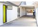 Side view of white house with an open carport, bright yellow door and access to a backyard at 1403 5Th Pl, Las Vegas, NV 89104