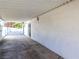 Spacious carport featuring a white brick wall and views into the yard at 1403 5Th Pl, Las Vegas, NV 89104