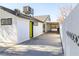 White exterior of home with a long carport and dark trim at 1403 5Th Pl, Las Vegas, NV 89104
