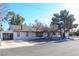 A charming white home exterior with an American flag and drought-resistant landscape at 1403 5Th Pl, Las Vegas, NV 89104