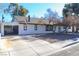 A charming white home exterior with an American flag and drought-resistant landscape at 1403 5Th Pl, Las Vegas, NV 89104