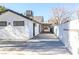 Exterior shot of a house and carport with new white paint and white walls along the driveway at 1403 5Th Pl, Las Vegas, NV 89104