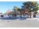 Charming single-story home with white painted brick and a well-manicured yard with trees at 1403 5Th Pl, Las Vegas, NV 89104