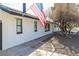 White painted brick home with mature trees featuring an American flag on the front of the home at 1403 5Th Pl, Las Vegas, NV 89104