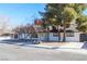 Charming single-story home with white painted brick and a well-manicured yard with trees at 1403 5Th Pl, Las Vegas, NV 89104