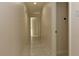 Hallway with pristine tile flooring, neutral walls, and multiple doorways at 1403 5Th Pl, Las Vegas, NV 89104